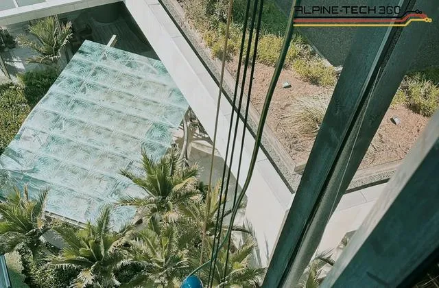 Alpine-Tech 360 rope access technician carrying out a water leak test on a glazed atrium roof in Auckland