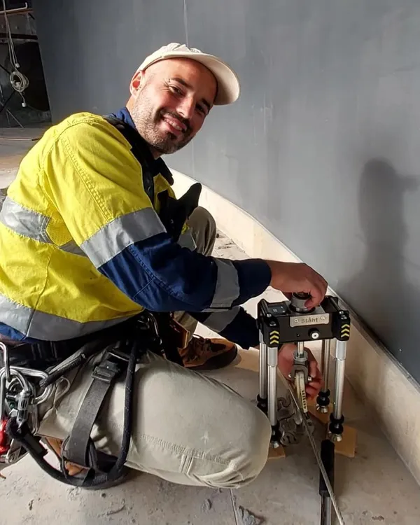 Alpine-Tech 360 technician pull-testing a roof anchor with a STAHT T25 tester